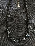 Collier en pierre noire acier inoxydable doré trefle à 4 feuilles